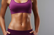 © Octopus - A closeup view of a fit individual showcasing a toned midsection celebrating health and fitness