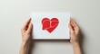 © Dis studio - Hands Holding Paper with Heart Illustration for Hepatitis Awareness on world hepatitis day