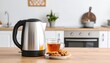 © Stefan Schurr - Modern electric kettle with glass cup of hot tea and sweet cookies on wooden table in kitchen