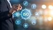 © Yassine - Businessman interacts with a digital interface displaying iso certification and interconnected business icons