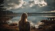 © Azor - A woman with long blonde hair gazes out at a serene lake under a cloudy sky on an autumn day landscape