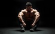 © li - A dramatic photograph of a man sitting on the floor, emphasizing his muscular form under moody lighting with dark boots in the foreground. High quality