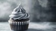© Kintsugi91 - A single decadent chocolate cupcake is displayed, frosted with swirls of elegant grey buttercream icing.