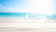 © Nicole - blurred white sand beach background with sunshine bokeh, blue sky and turquoise water