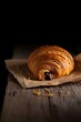 © Yudooo - Rustic Chocolate Croissant with Melted Filling - Dark Food Illustration Style