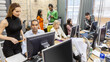 © track5 - The Media Agency: Creative Office. Candid view of a busy contemporary office scene with creative professionals working in an open environment. From a series of related images.
