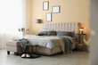 © New Africa - Comfortable bed with soft linens and blankets in room. Home textile