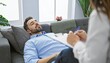 © photostockatinat - Man lying on couch during therapy session