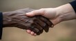 © Ahmdfadhilah - Diversity handshake uniting different skin tones conveys cooperation, partnership and equality symbol