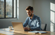 © Amiril - Portrait of young man sitting at his desk in the office