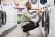 © Serhii - Customer choosing washing machine in electronics store