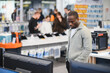 © Serhii - Customer choosing tv in electronics store at mall