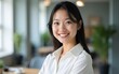 © li - Close up head shot portrait of young smiling Asian businesswoman wear white shirt posing in office, looks positive, feels happy, gazing at camera. Professional occupation or teacher, profile picture