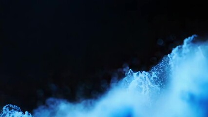 Wall Mural - blue particles exploding creating abstract shapes on black background