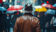 © Yurij - Man in a brown leather jacket and hat standing in the rain with colorful umbrellas in the background