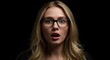 © Mono - Startled woman with glasses against black