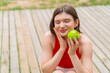 © luismolinero - Young pretty woman at outdoors holding an apple with happy expression