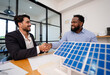 © PINA - team of coworker shaking hand for successful solar roof system project with house model, responsible of green industry alternative renewable clean environment energy for sustainable business
