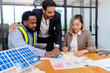 © PINA - team of multiethnic coworker meeting on solar roof system project with solar panel house model, responsibility of green industry alternative renewable clean environment energy for sustainable business