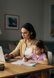 © AswinRizky - Young woman working from home while her daughter does her homework, a scene of modern parenting, Mother and daughter at the table, working and studying at home