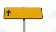 © Wool World - Yellow Directional Sign with Arrow Against White Sky Guidance and Orientation for Navigation