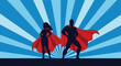 © arfanah02 - A dynamic silhouette of a superhero couple with flowing capes against a blue radial background, symbolizing power, strength, and heroic action