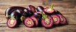 © Priwan - Deep purple eggplant slices arranged artfully on a rustic wooden surface,  healthy,   market