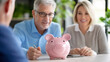 © Chineewan Somsap - Financial advisor discussing savings with clients, featuring pink piggy bank on table, conveying trust and financial planning