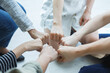 © AU USAnakul - Close-up of diverse team members doing fist bump in unity, symbolizing teamwork, trust, and mutual support in modern collaboration.