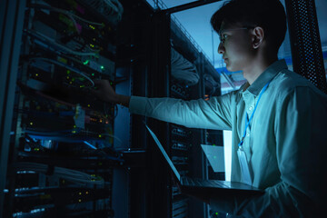 computer engineer is setting up network in server room,systems maintenance technician,male engineer 