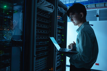 computer engineer is setting up network in server room,systems maintenance technician,male engineer 
