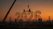 © tea - Construction Workers Building 2026 at Dusk - Teamwork, progress, construction, future, new year. Silhouetted workers build a large 2026 structure on a construction site at sunset