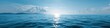 © Andrii Zastrozhnov - Tranquil ocean panorama at sunrise with sparkling waves and distant mountains