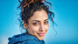 © Vishwesh - Middle eastern arabic young lady portrait of a beautiful woman with curly hair and blue background stock photo and image for commercial use