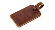 © Ingrid - A close up shot of a brown leather luggage tag with a brass buckle on a black background