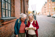 © Davor - Senior women exploring city with map
