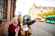 © Davor - Senior couple exploring city with map and coffee