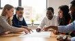 © PixelDust_ - Diverse team meeting around table discussing project, collaboration, and planning