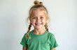 © Vadym - Portrait of young girl with blonde braided hair styled in buns. She wears green t-shirt and smiles brightly at camera. Her joyful expression and innocent eyes create heartwarming, carefree mood.