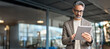 © insta_photos - Busy mature older business man executive standing in office using digital tablet. Middle aged professional businessman corporate manager wearing suit and glasses holding tab working on finance project