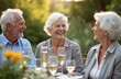 © Vadym - Three elderly friends share laughter, drinks at outdoor dinner table during summer. White-haired seniors enjoy meal in park setting, radiating happiness, companionship. Mature couple, friend share