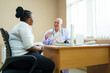 © DG PhotoStock - African woman have a medical examine and checkup with doctor in hospital.