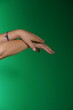 © Artframe  - Close-Up of Woman’s Hands on Green Studio Background – Unedited Natural Skin Detail
