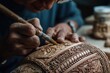 © Сергей Косилко - The artisan carves intricate designs and decorations into the wooden object.