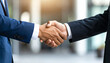© Pastel - A professional handshake symbolizing agreement and partnership in a business context, with blurred background emphasizing the moment