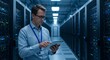 © ekalaila - Data center employee with tablet manages server hardware
