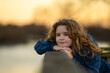 © Volodymyr - Dreamy little. Relaxed child feeling the breeze in the park. Thoughtful expression on a child face. Future thinker enjoying a quiet day. Portrait of a peaceful child. Cute child exploring imagination.