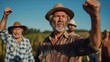 © Valeriia - Elderly man with gray beard and straw hat raises fist in solidarity, surrounded by fellow farmers in a field, expressing unity and determination for agricultural rights and community strength