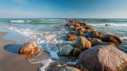 Wall Mural - Rocky breakwater stretches into the calm sea under a blue sky. Use this for travel blogs, coastal themes, and vacation ads.