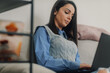 © Ljustina - Focused woman working from home on laptop, remote work and online business